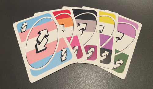 Cards with LGBTQ+ color schemes from left to right: Trans, Lesbian, Asexual, Non-Binary, Genderqueer